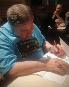 Dr. Howard M. Berlin signing his book "The Numismatourist" at the World's Fair of Money 2014