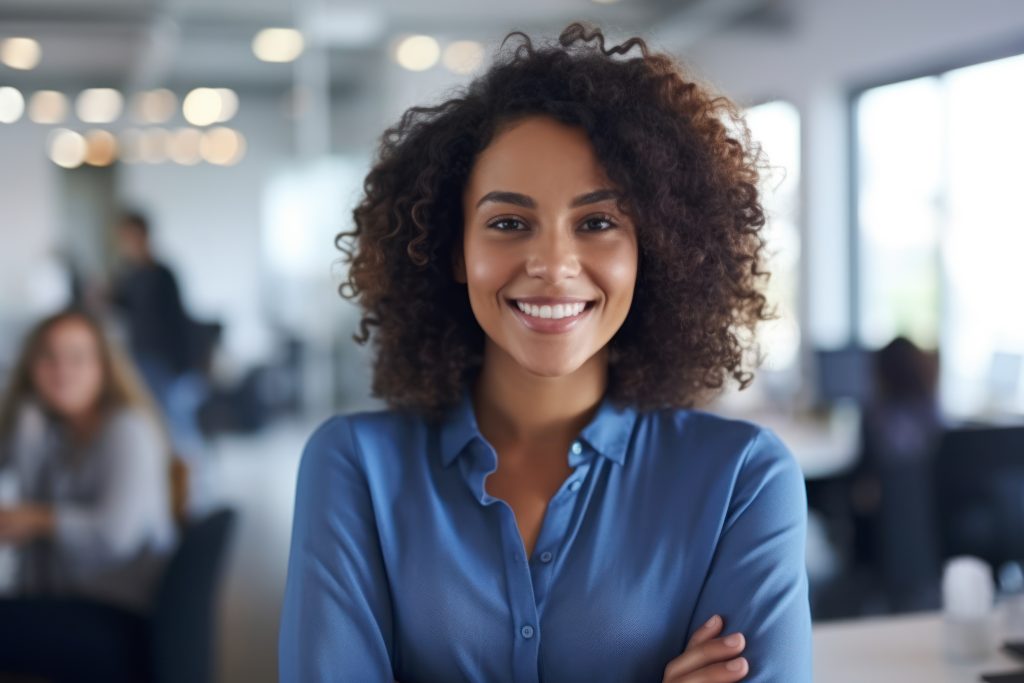 happy young woman sitting in her chair smiling.